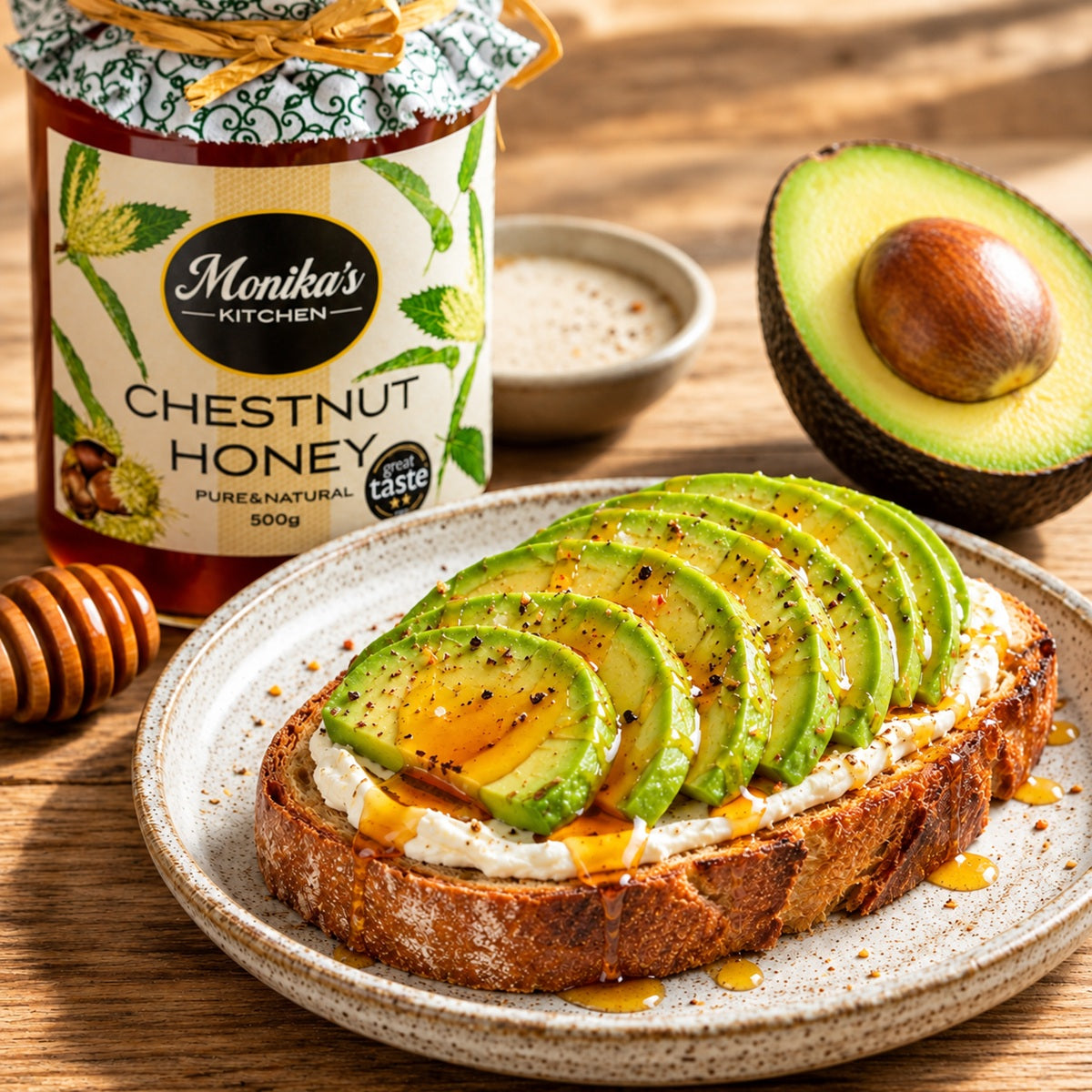 Avocado toast on a plate with Monika's Kitchen chestnut honey jar and an avocado in the background.