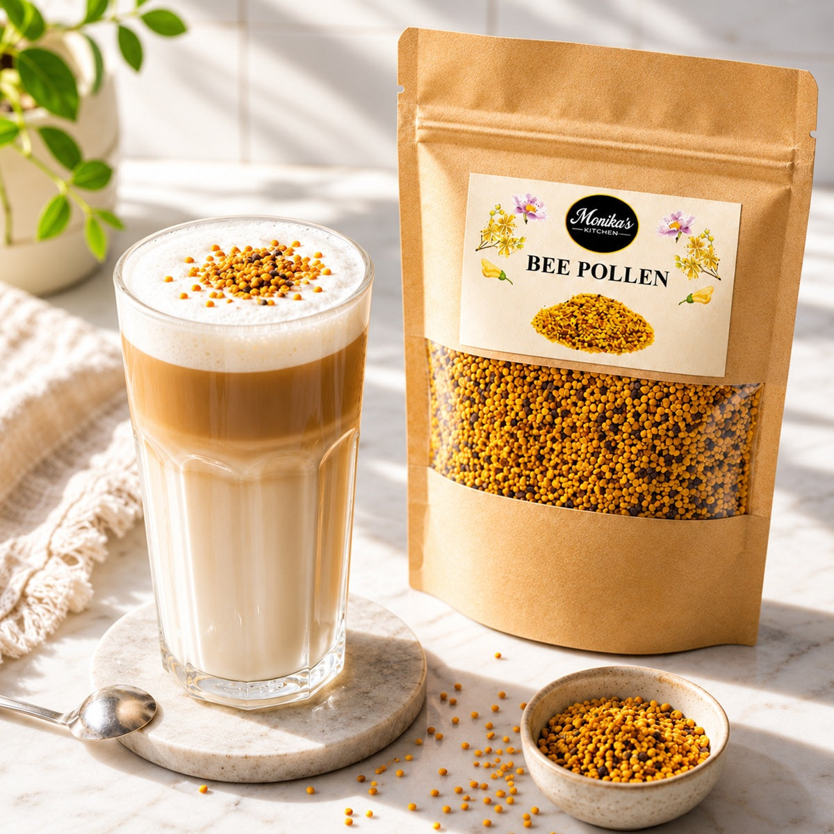 A glass of coffee latte with bee pollen on a marble surface next to a package of Monika's Kitchen Bee Pollen.