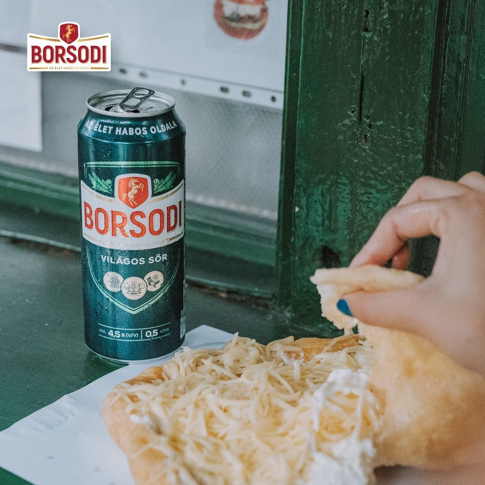 A can of Borsodi beer with a Hungarian Lángos fried flatbread from Budapest.