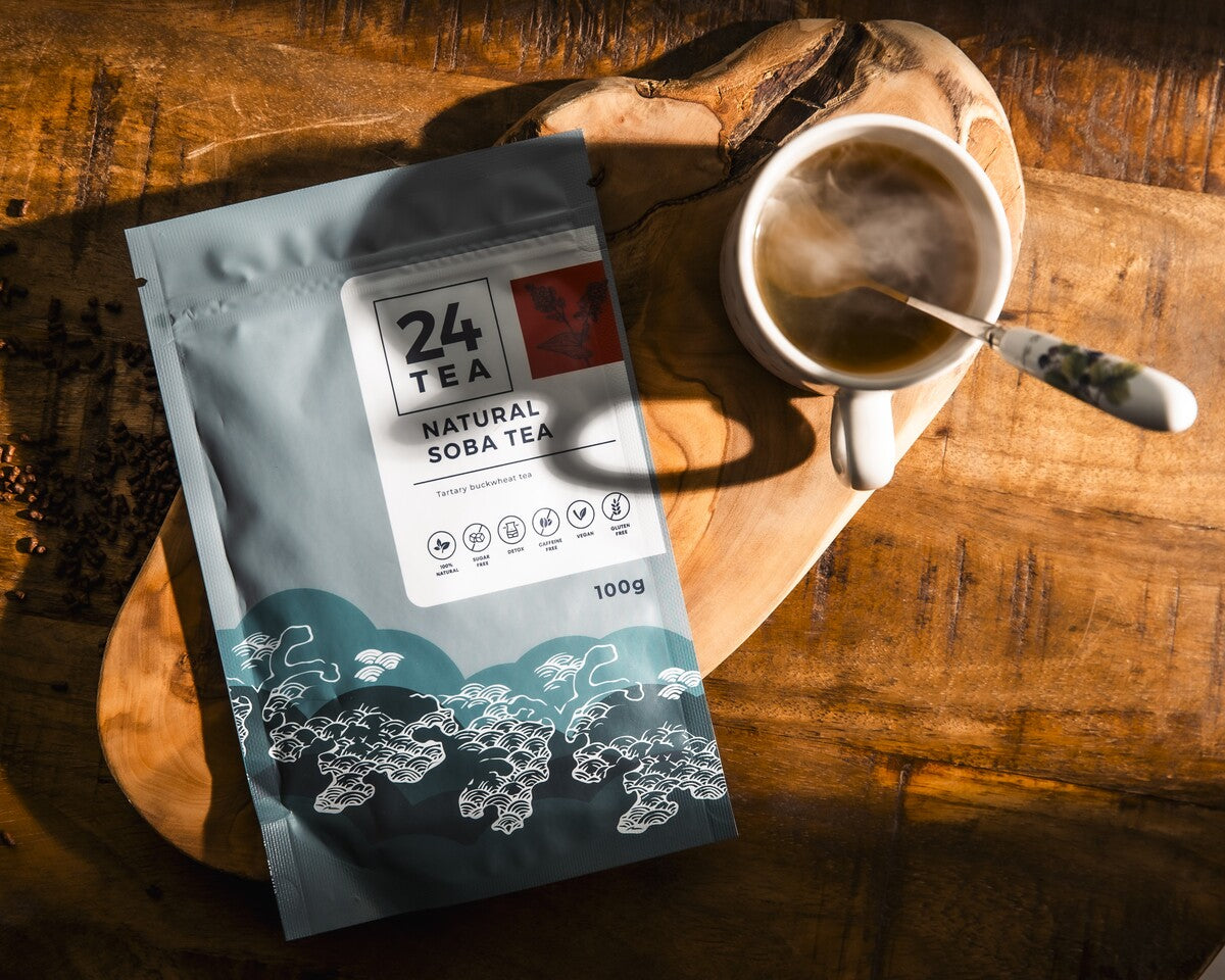 A steaming cup of Tartary buckwheat tea with a pack of buckwheat tea on the side.