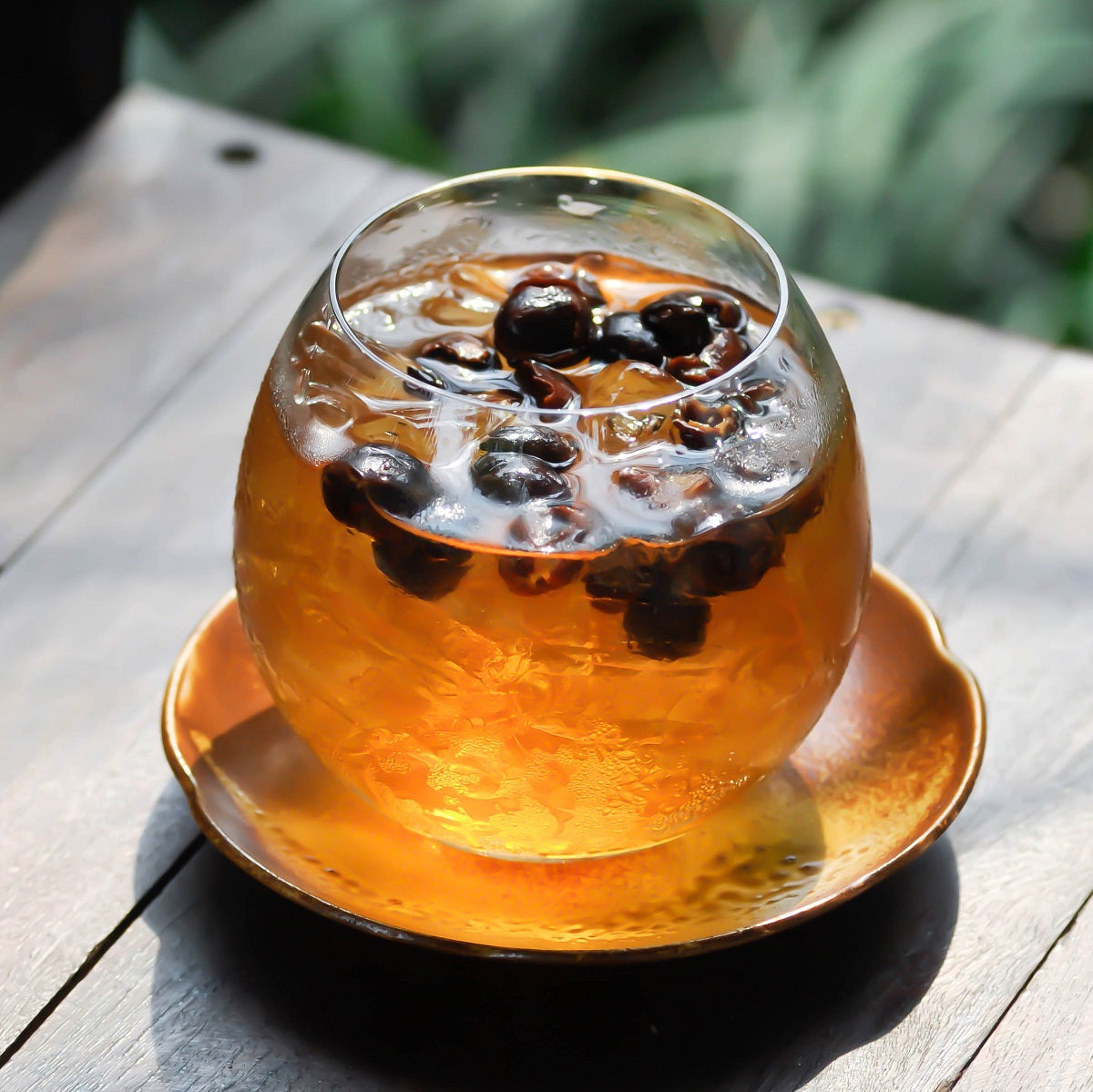 A cup of iced Cascara tea made from dried coffee cherries.