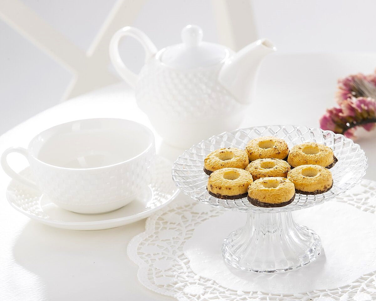 A plate of chocolate and vanilla biscuits with afternoon tea.
