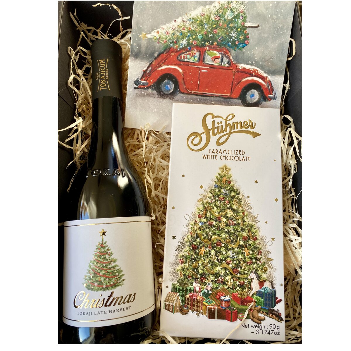 A Christmas chocolate and wine hamper, the gift box contains a bottle of wine and chocolate bars.