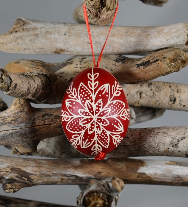 A hand painted red Easter egg decoration.