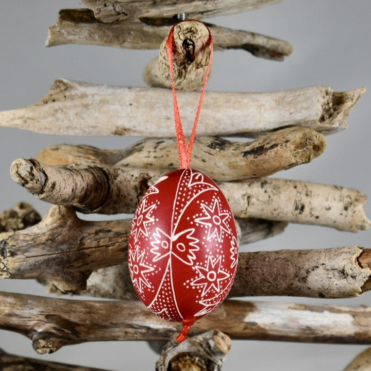 A hand painted red Easter egg ornament.