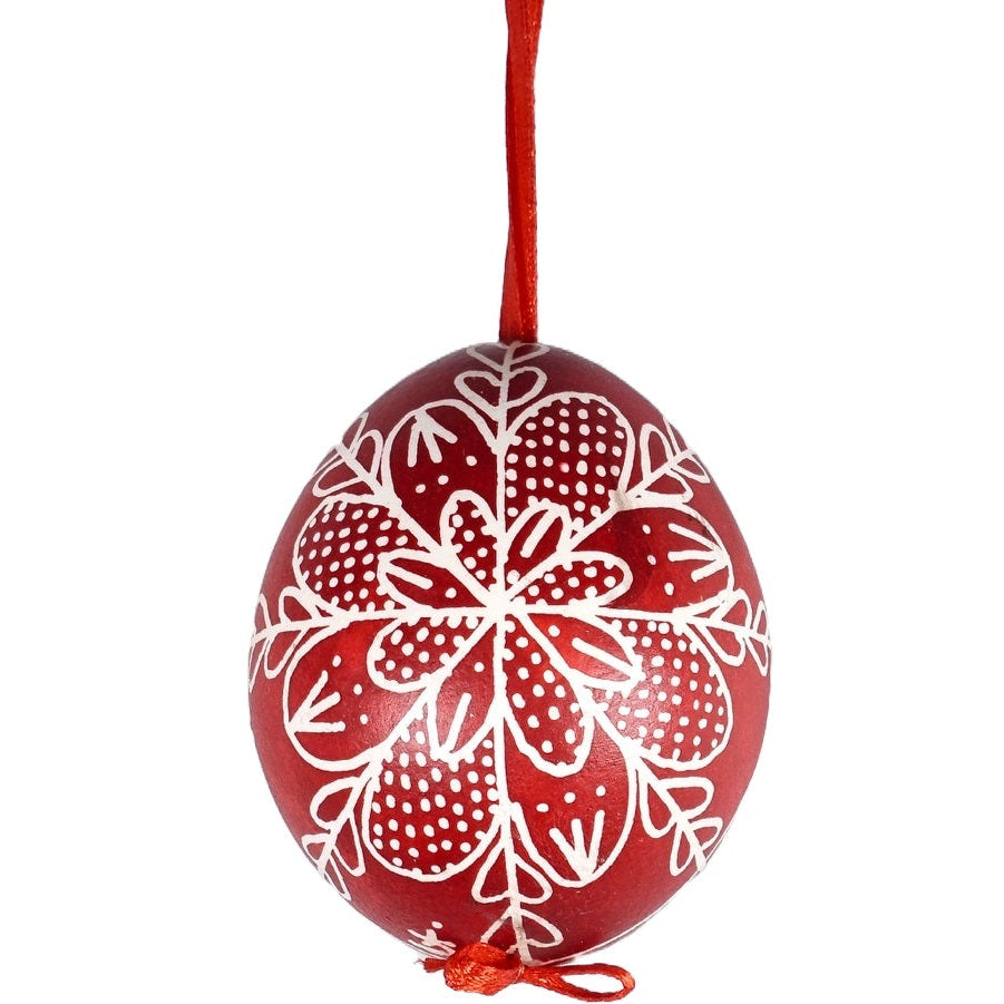 A hand painted Hungarian red Easter egg with a traditional design drawn by hand.