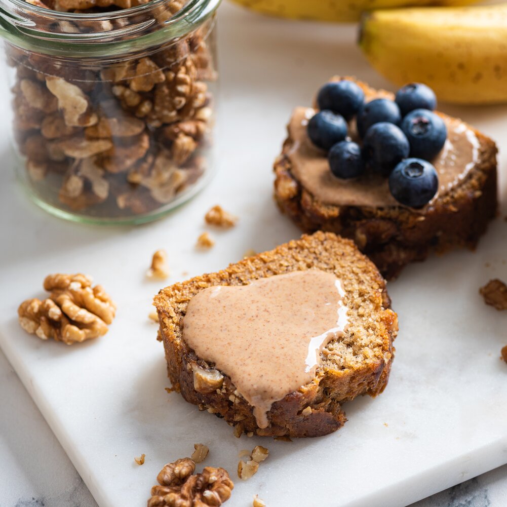 Creamy walnut butter spread over walnut cake for a healthy snack.