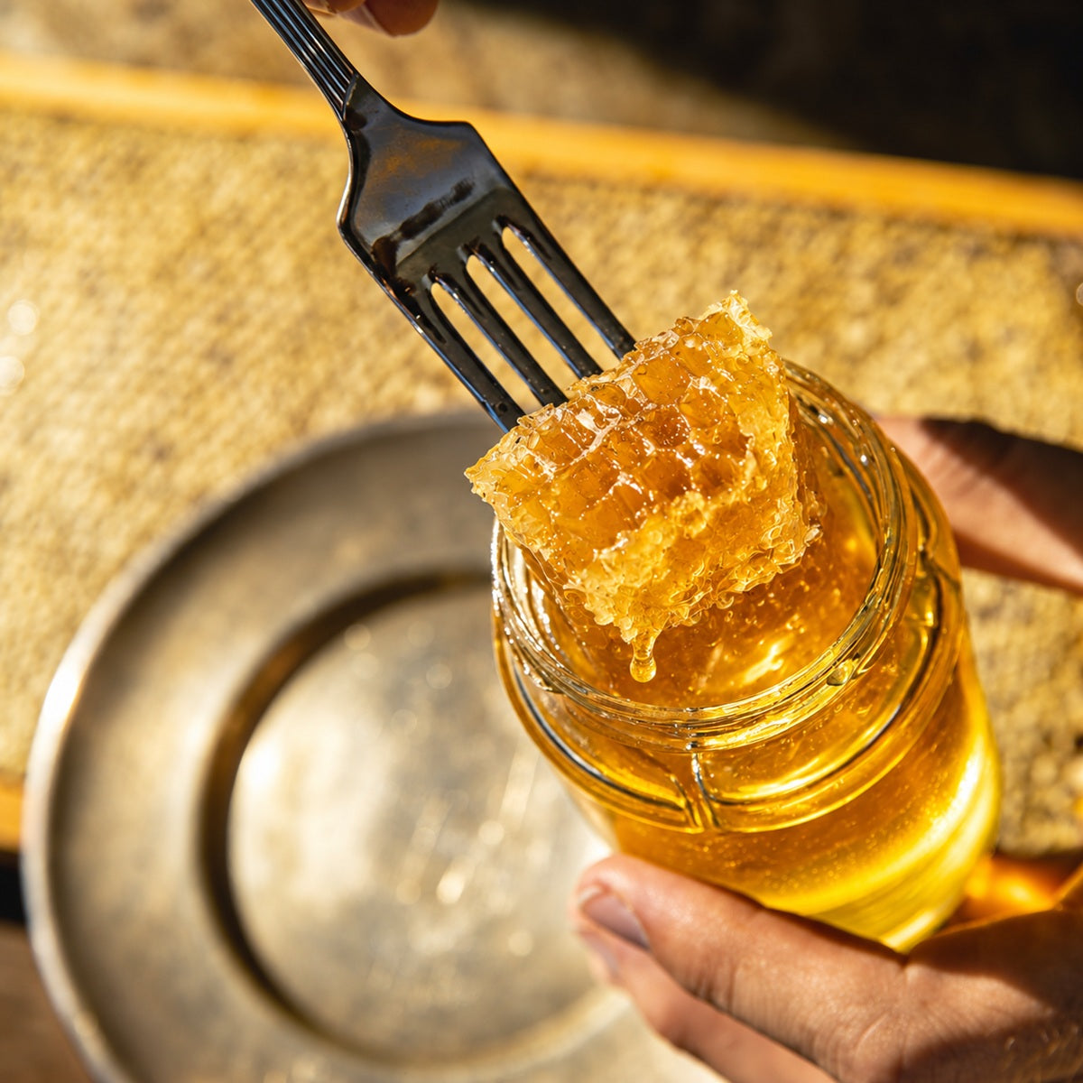 A piece of fresh bee honeycomb in a jar of honey for eating.
