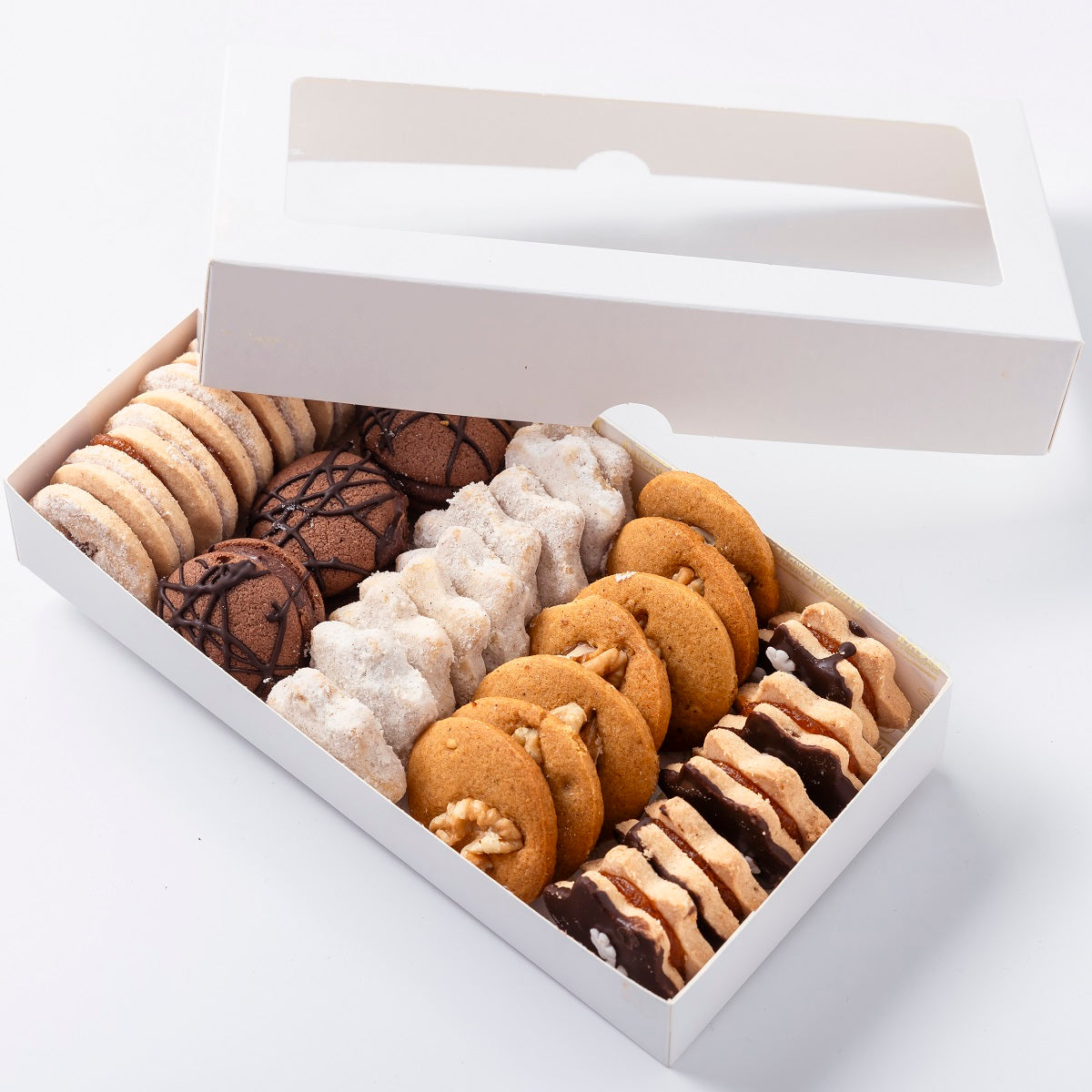 A box of Hungarian petits fours mini cakes including an assorted selection of traditional cookies and biscuits.