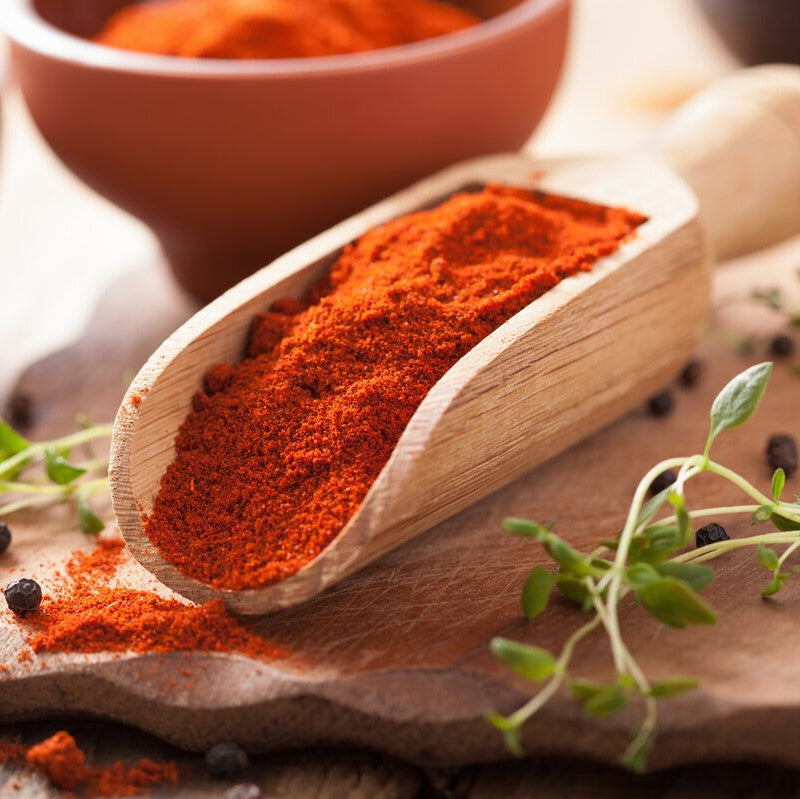 A spice scoop of Hungarian sweet smoked paprika powder.