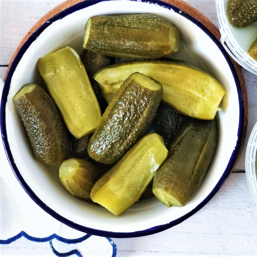 A plate of kovászos uborka, which are Hungarian fermented cucumber pickles.