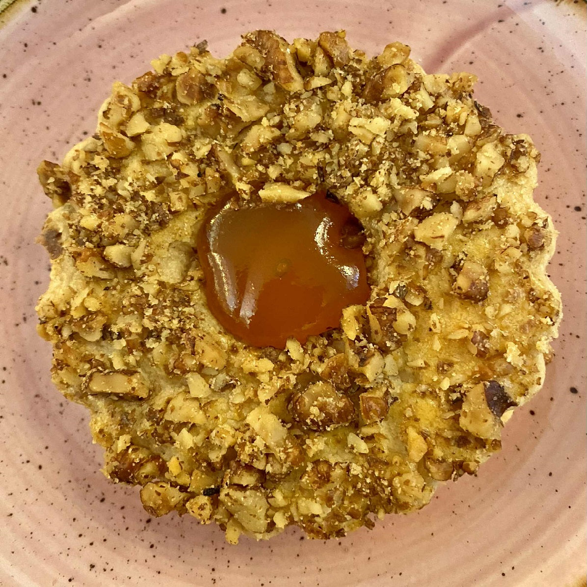 A pair of Linzer cookies, a traditional Austrian biscuit made with apricot jam.