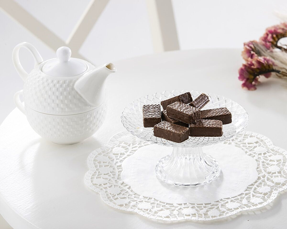A plate of mini milk chocolate wafer cookies with tea.