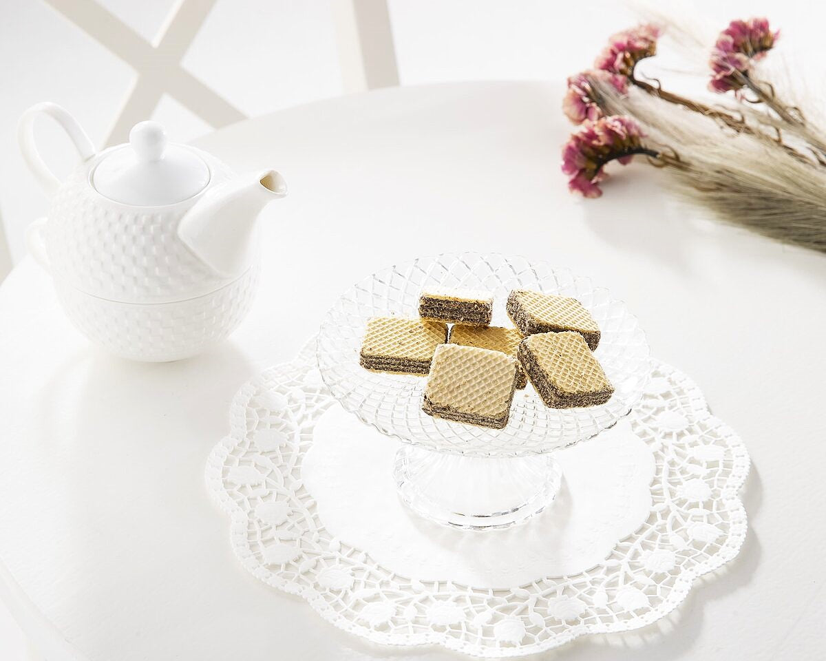 A plate of milk chocolate wafers with tea.