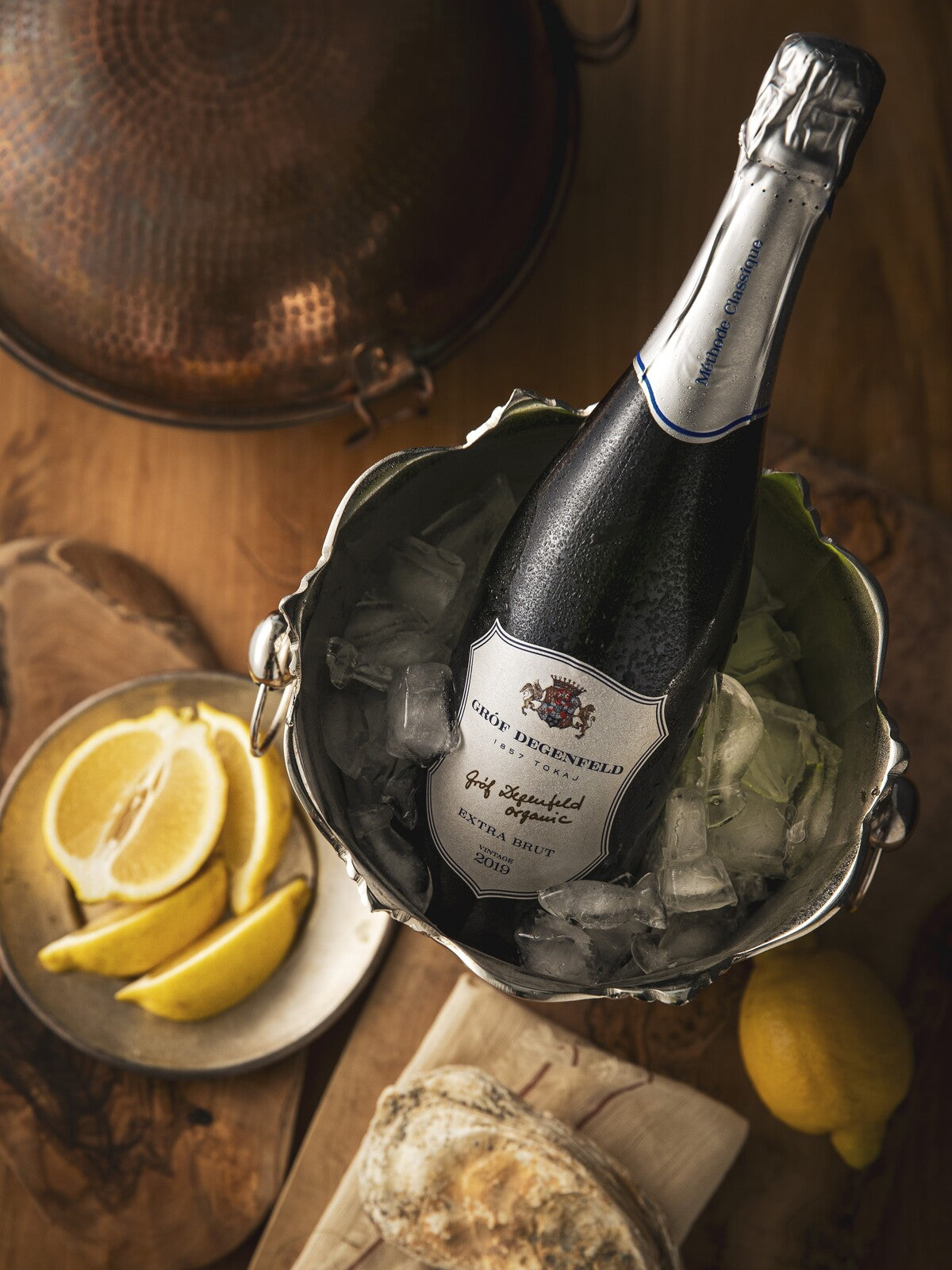 A glass of Tokaji sparkling wine from Hungary is the perfect drink pairing with oysters, served with lemon slices.