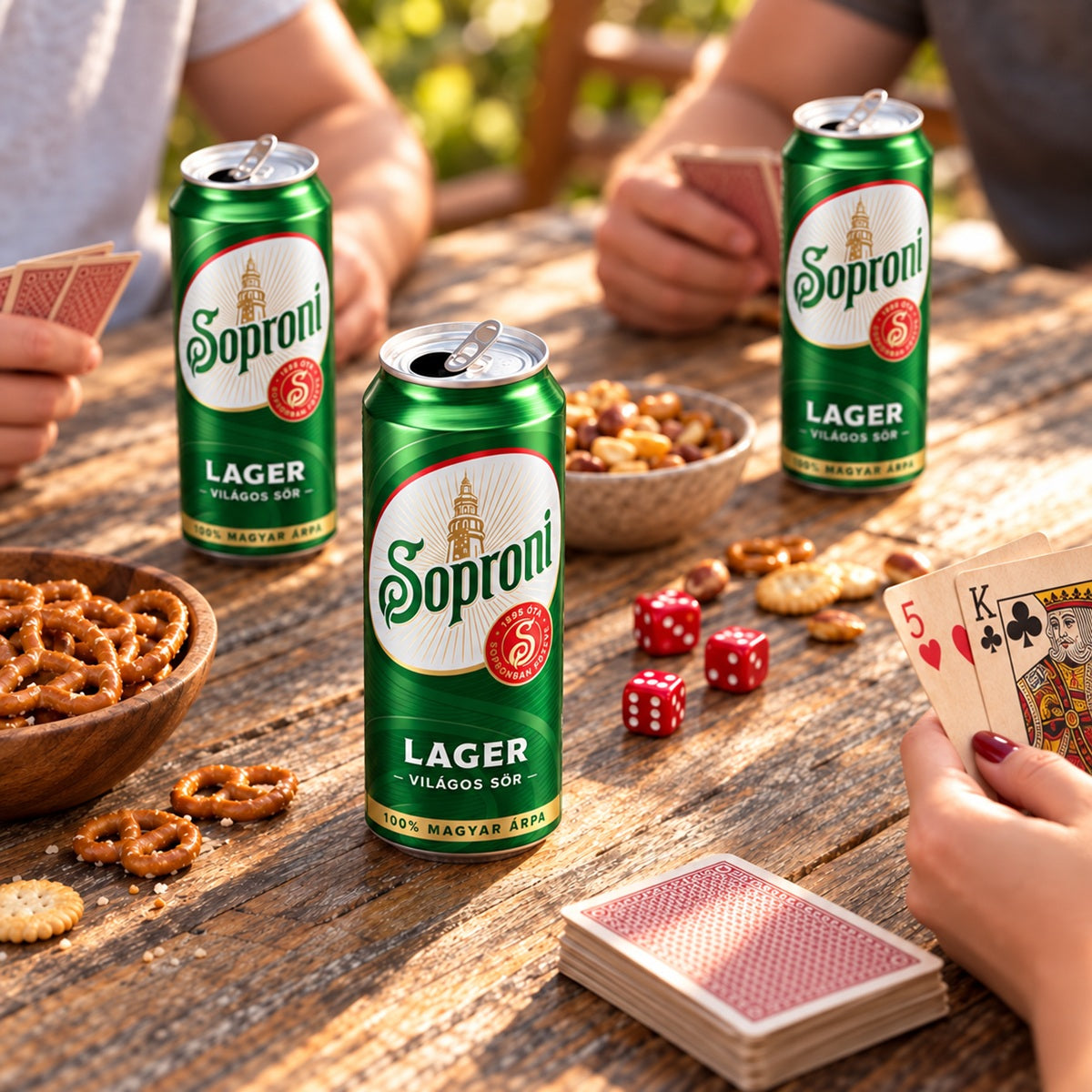 Three cans of Soproni lager on a table, one of the most popular Hungarian beer brands.