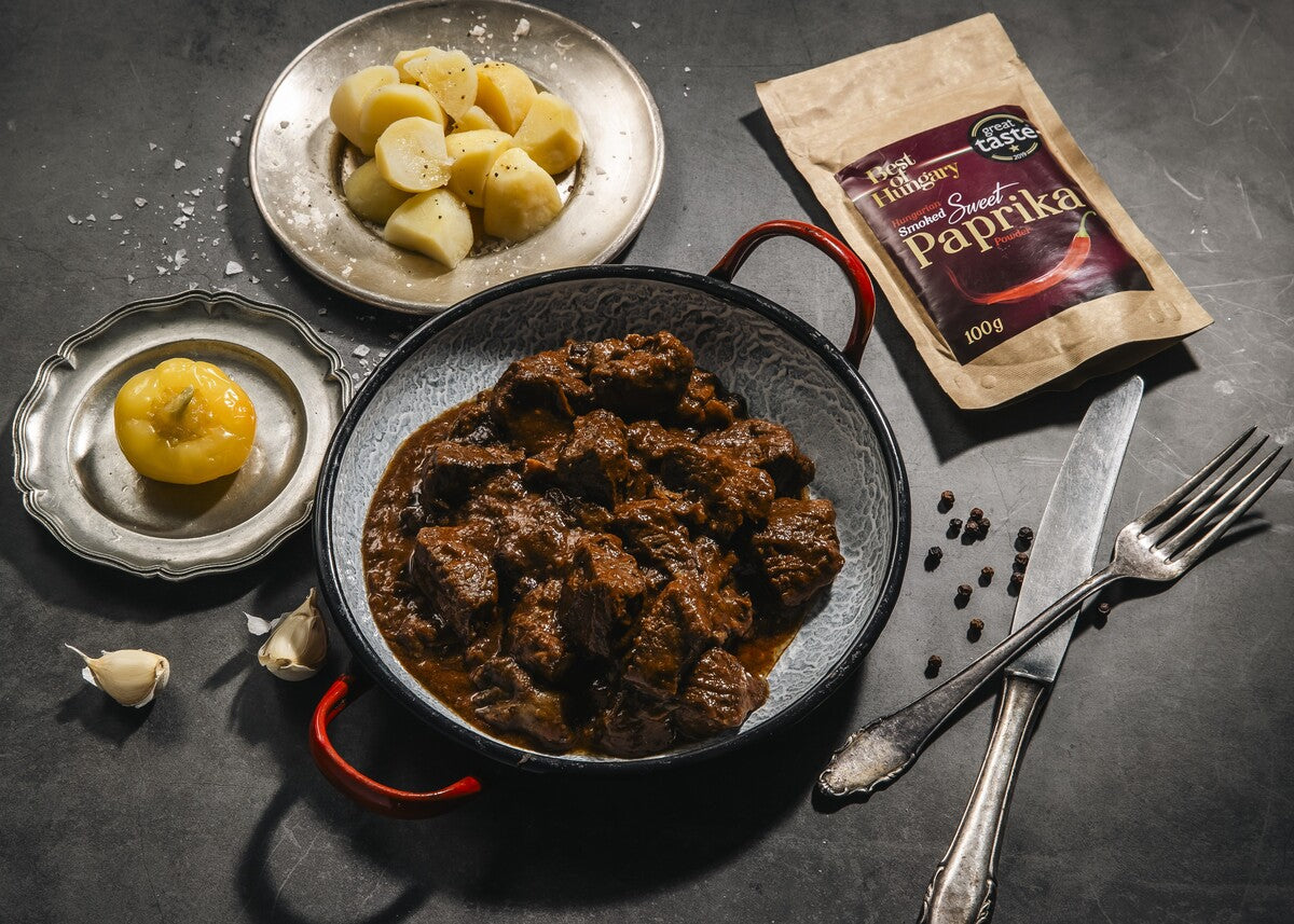 A beef goulash stew recipe made with Hungarian sweet smoked paprika powder and served with pickles.