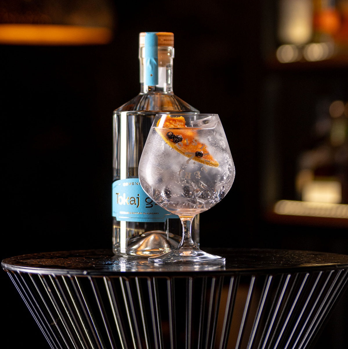 A bottle and a glass of Tokaji gin, an award-winning Hungarian London-style dry gin.