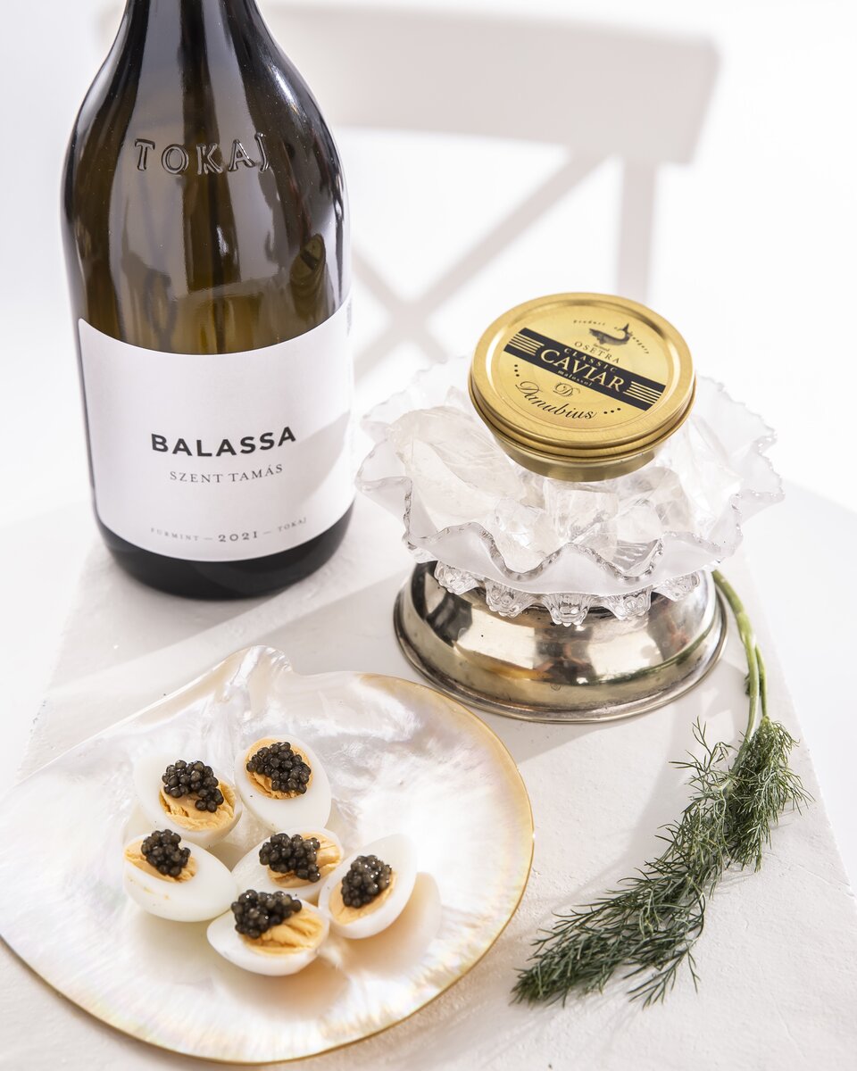 A glass of furmint white wine is the best pairing for caviar, served with hard-boiled quail eggs.