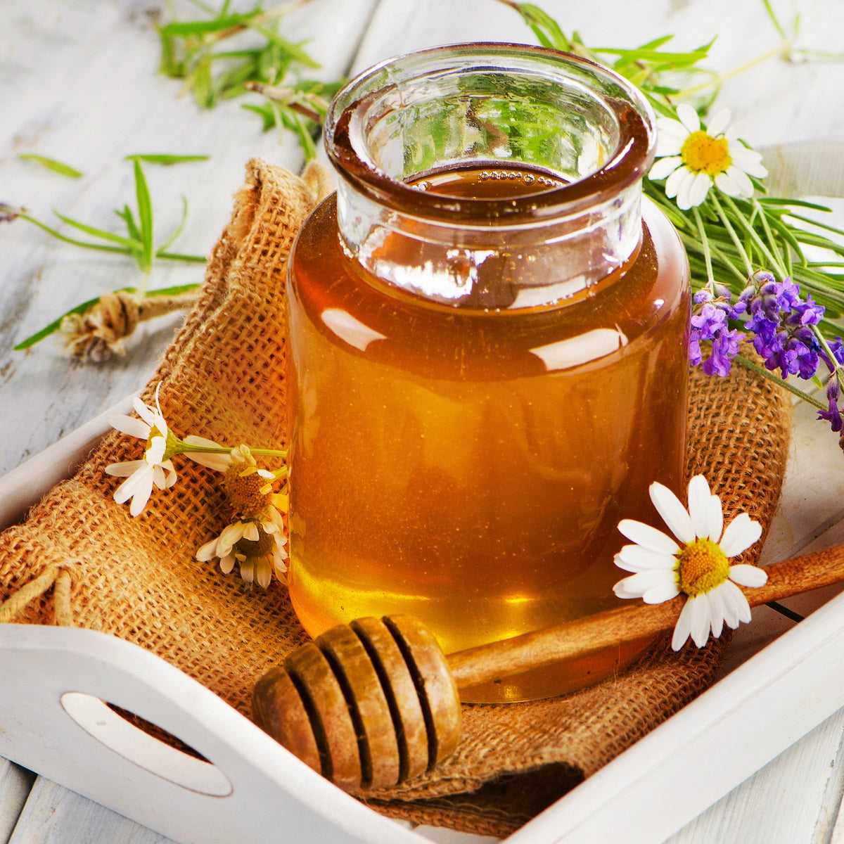 A jar of raw wildflower blossom honey, the best pure and natural honey from fresh flowers.