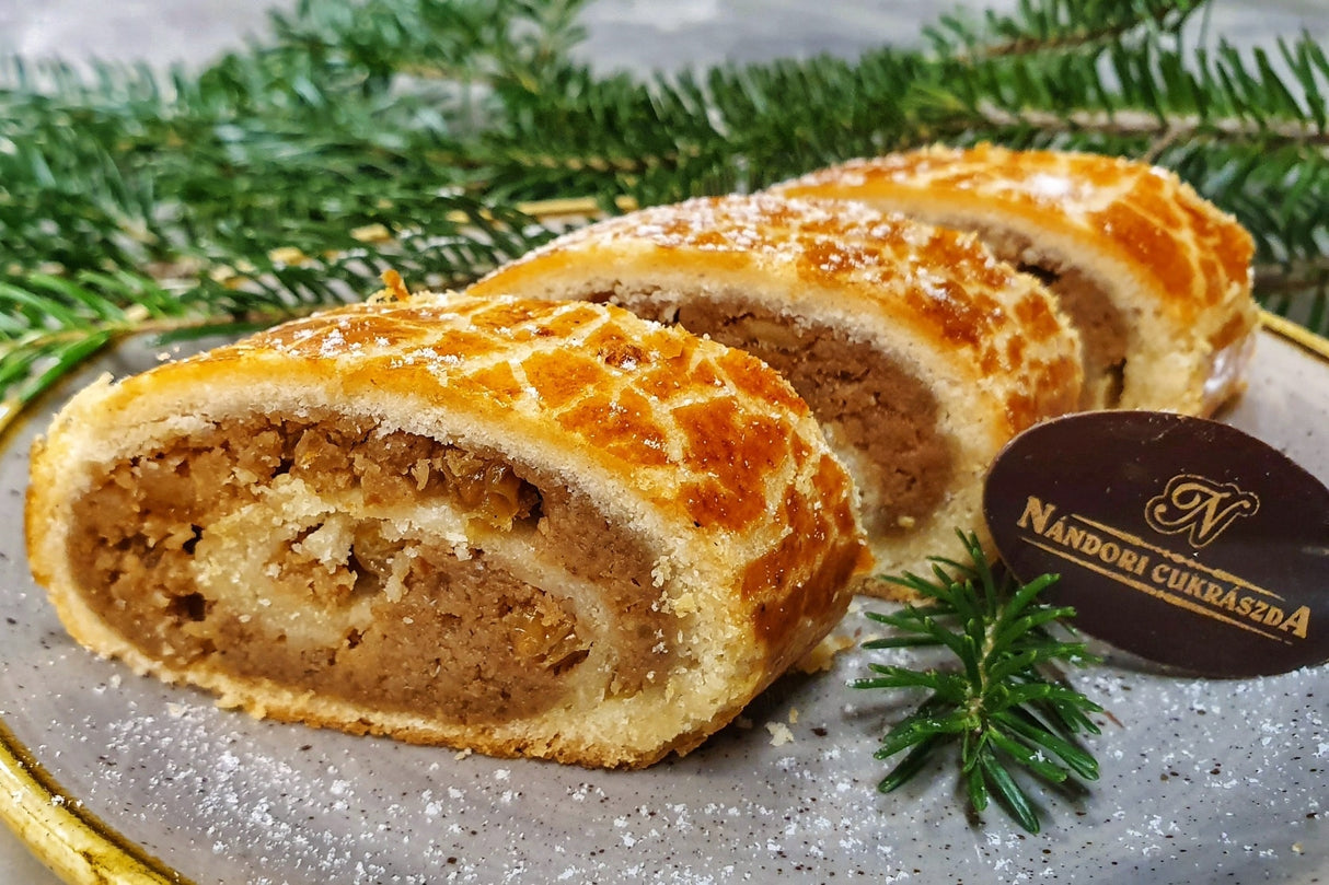 Dios beigli is a Hungarian walnut cake recipe with a filling of ground walnuts, golden raisins and candied orange peel.