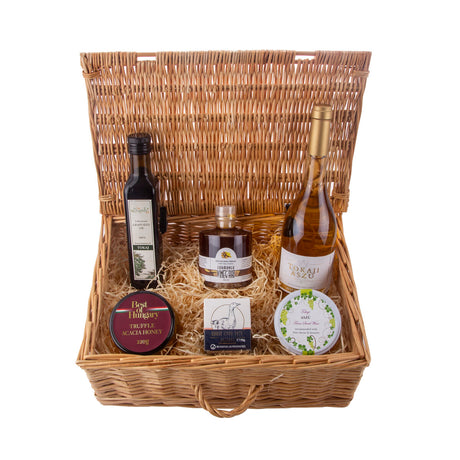 A luxury food and wine gourmet gift hamper basket with a bottle of wine and the best fine food delicacies.