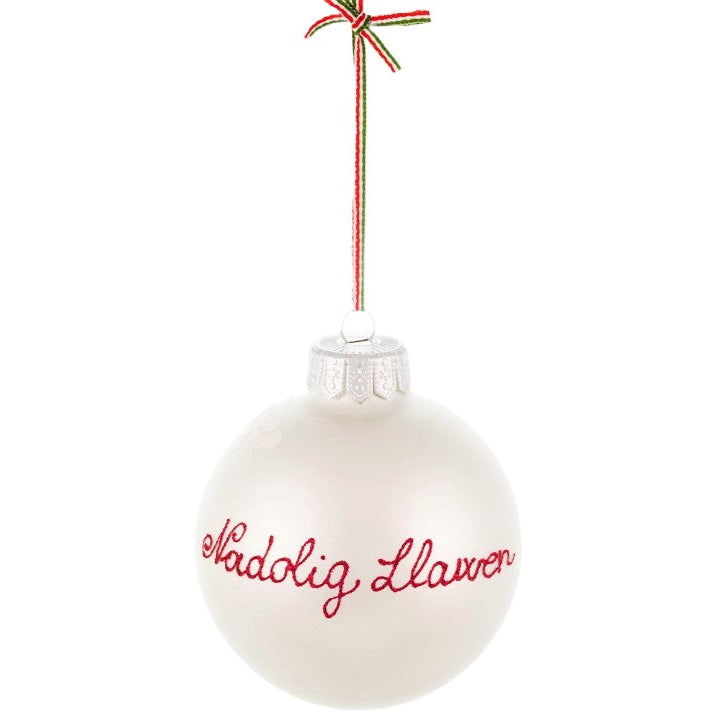 A Welsh Christmas tree bauble with the hand-painted greeting "Nadolig Llawen" for wishing a Merry Christmas.