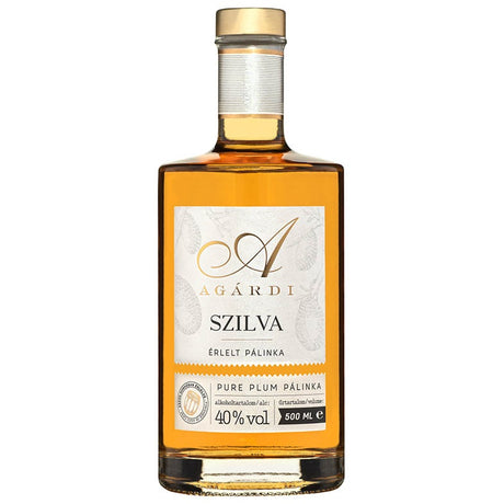 A bottle of premium Hungarian plum pálinka aged in an oak barrel.