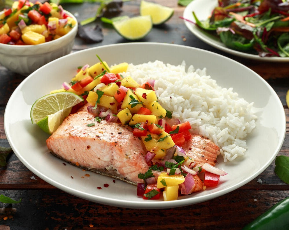 Oven baked salmon recipe with salad and a side of steamed white rice.