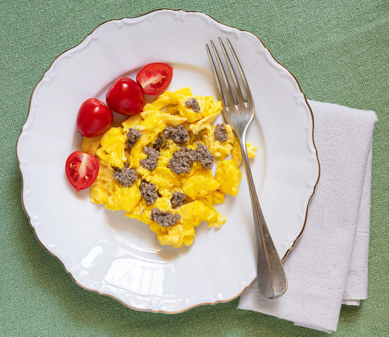 A gourmet scrambled eggs recipe with black truffle pesto.