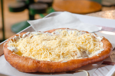 Lángos recipe for making the best Hungarian fried flatbread dough with cheese, a traditional street food from Budapest.