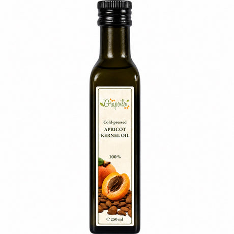 Bottle of cold-pressed apricot kernel oil on a white background.