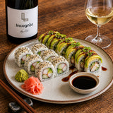 A glass of Blanc de Noir white wine paired with a plate of sushi.