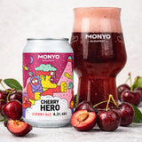 Can and a glass of cherry beer with fresh cherries in the foreground.