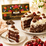 Chocolate cake with white frosting, cherries and decorated with cherry liqueur chocolate pieces.