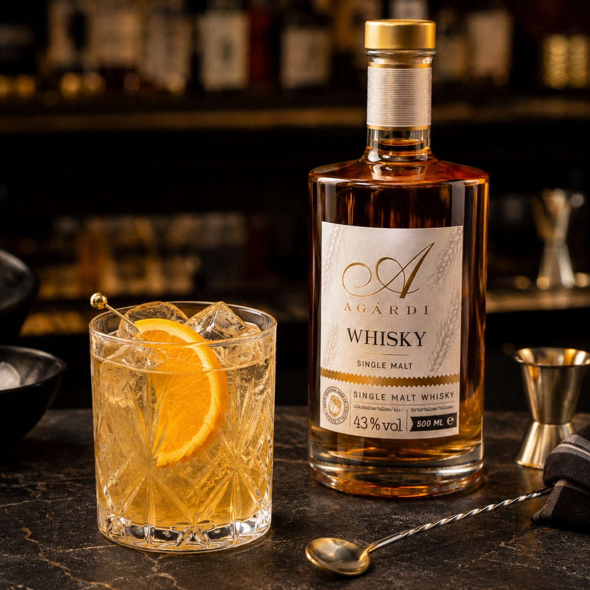 A whisky bottle with a glass of a classic cocktail with whisky on a bar counter.
