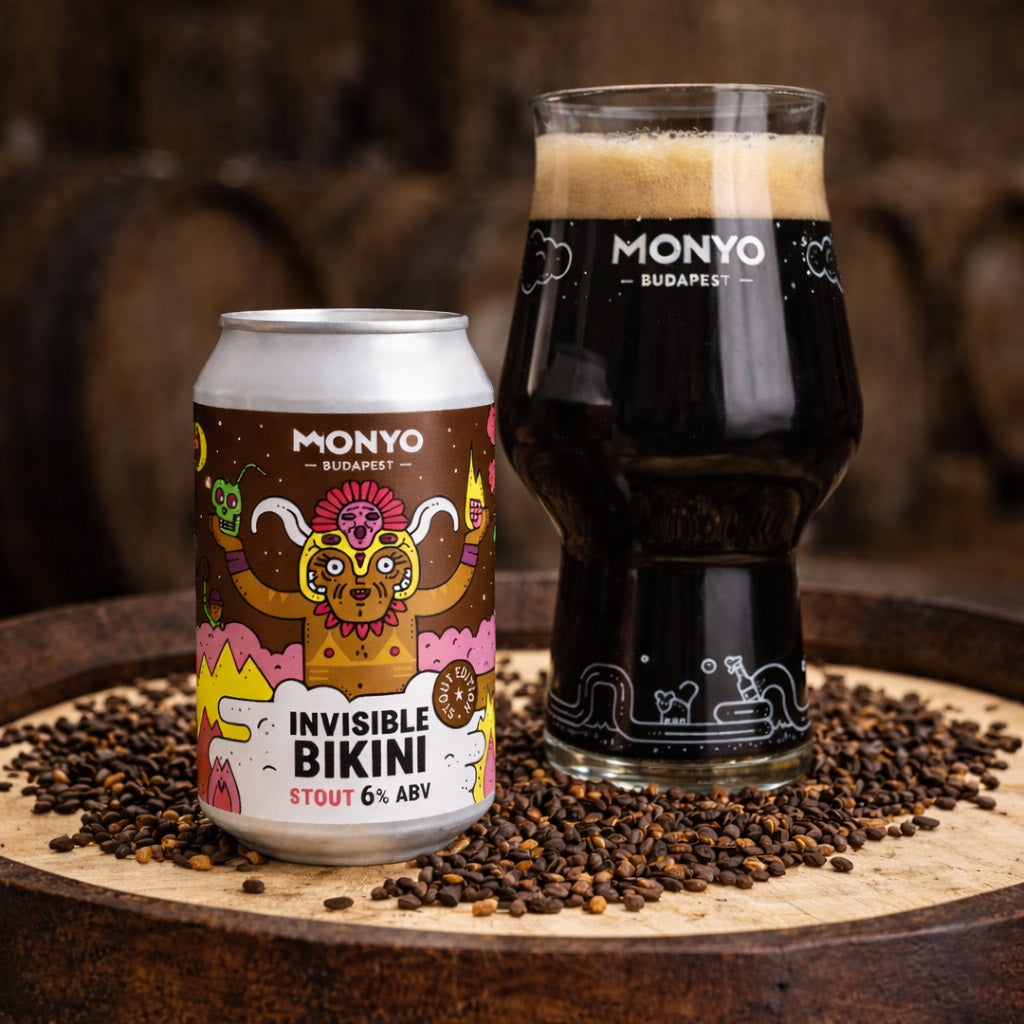 Can and glass of craft stout beer on top of a barrel, with roasted malts around them.