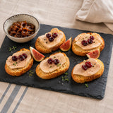 Elegant appetiser of crostini bread topped with duck liver foie gras terrine, dried cranberries and figs.