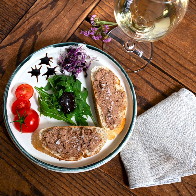 Slices of bread with duck liver pate and a glass of sweet Tokaji wine.
