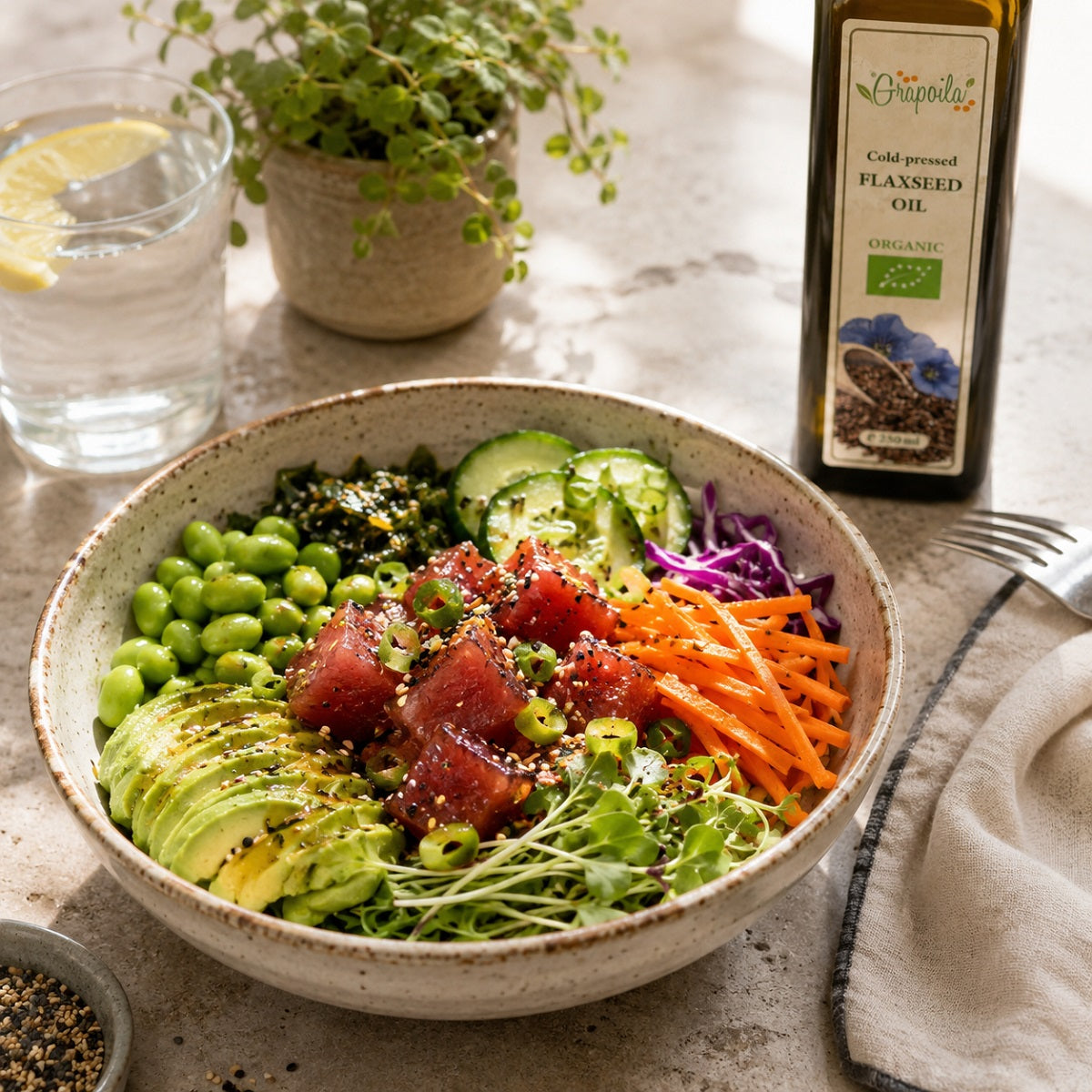 Poke salad in a bowl on a light background, with a bottle of organic flaxseed oil.