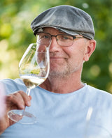 Hungarian winemaker Geza Legli with a glass of Matacs Chardonnay white wine.