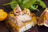 Whole pieces of goose liver foie gras on toast with fig and black pepper.