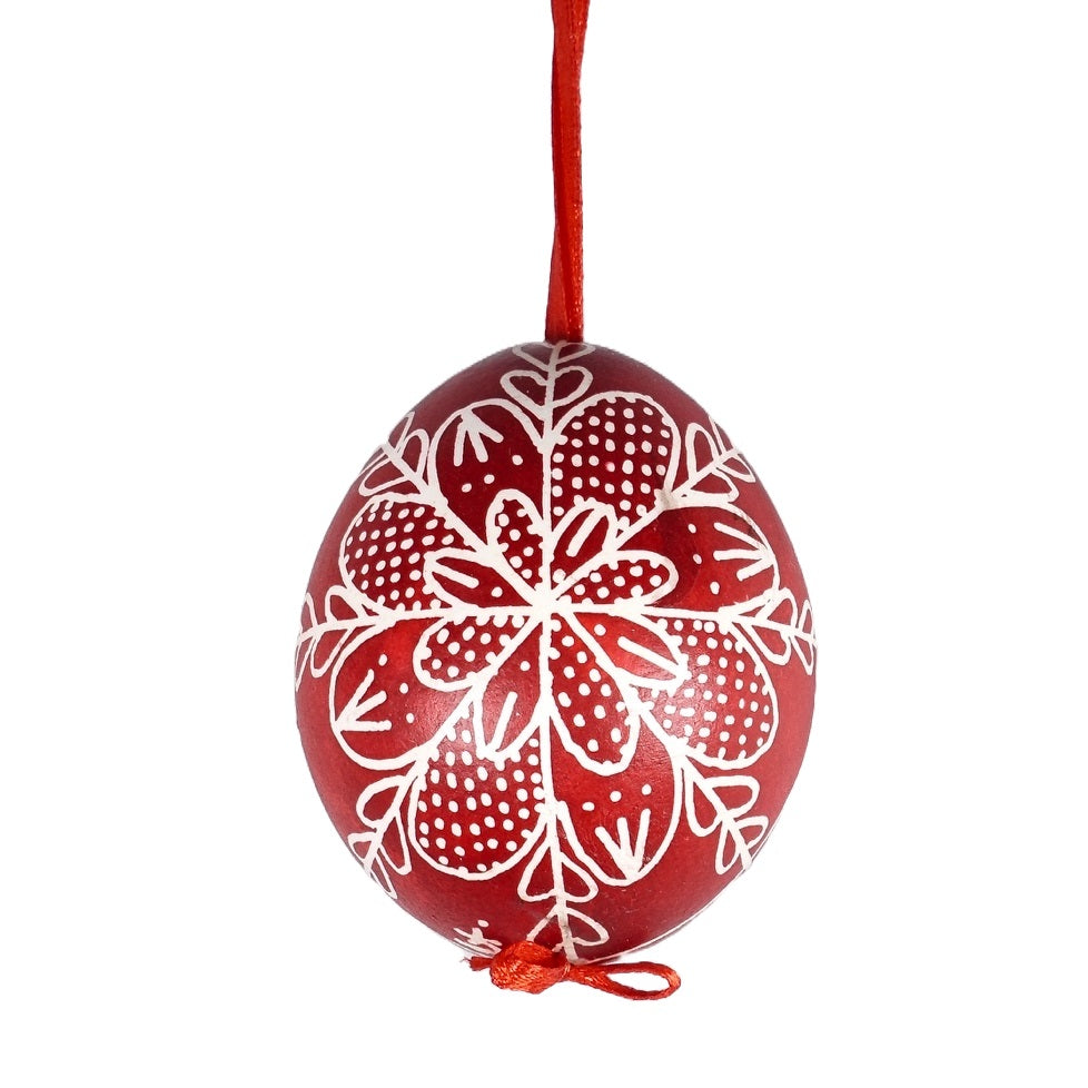 A hand painted Hungarian red Easter egg with a traditional design drawn by hand.