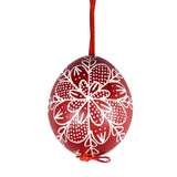 A hand painted Hungarian red Easter egg with a traditional design drawn by hand.