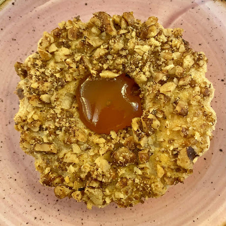 A pair of Linzer cookies, a traditional Austrian biscuit made with apricot jam.