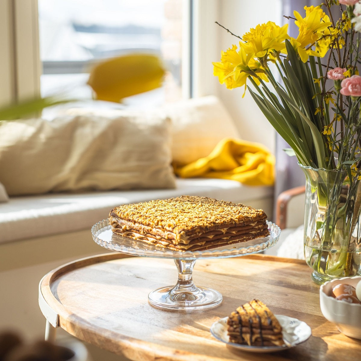 A whole piece of Marlenka Honey Cake on a cakestand.