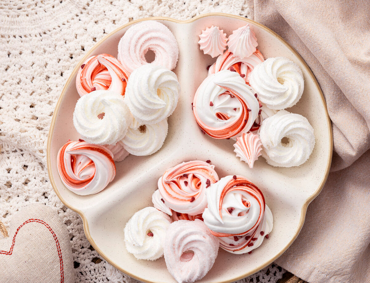 Heart-shaped plate with pink and white meringue nests.