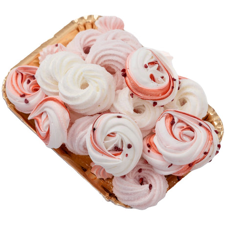 A plate of white, pink and red meringue nests.