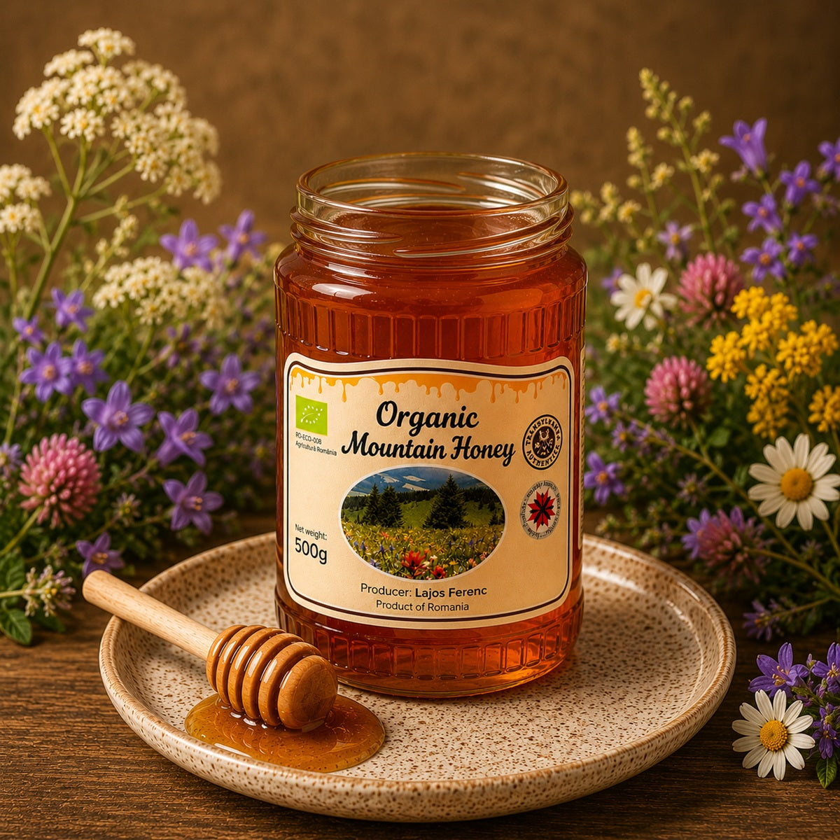Jar of Organic Mountain Honey with a honey dipper on a plate surrounded by alpine flowers