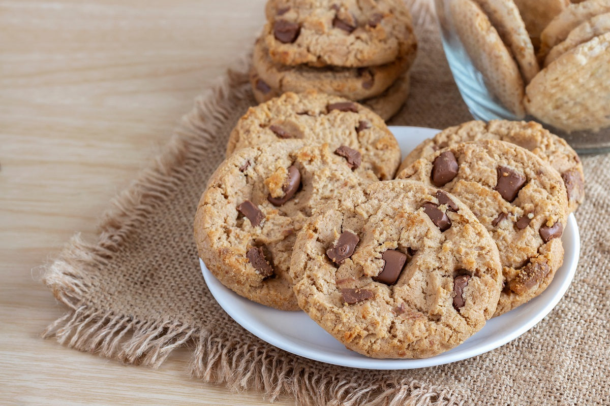 A plate of orange chocolate chip cookies made with candied orange peel and Belgian dark chocolate chips.